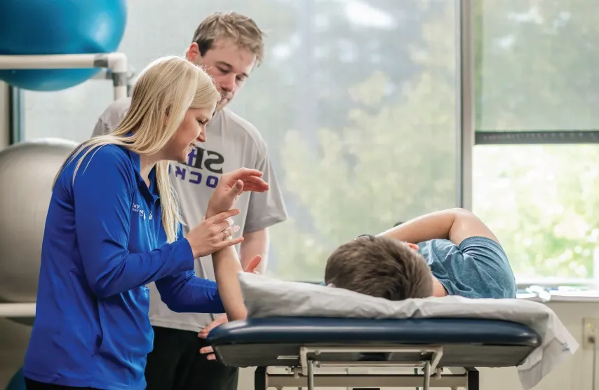 Student assisting with Physical Therapy