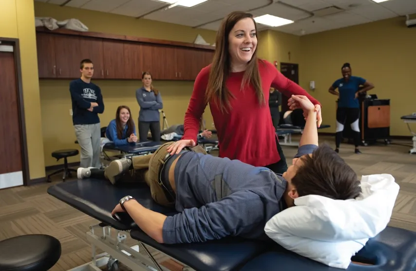 PT student practicing techniques in lab setting.