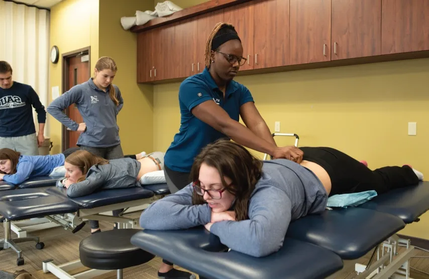 PT student practicing techniques in lab setting.